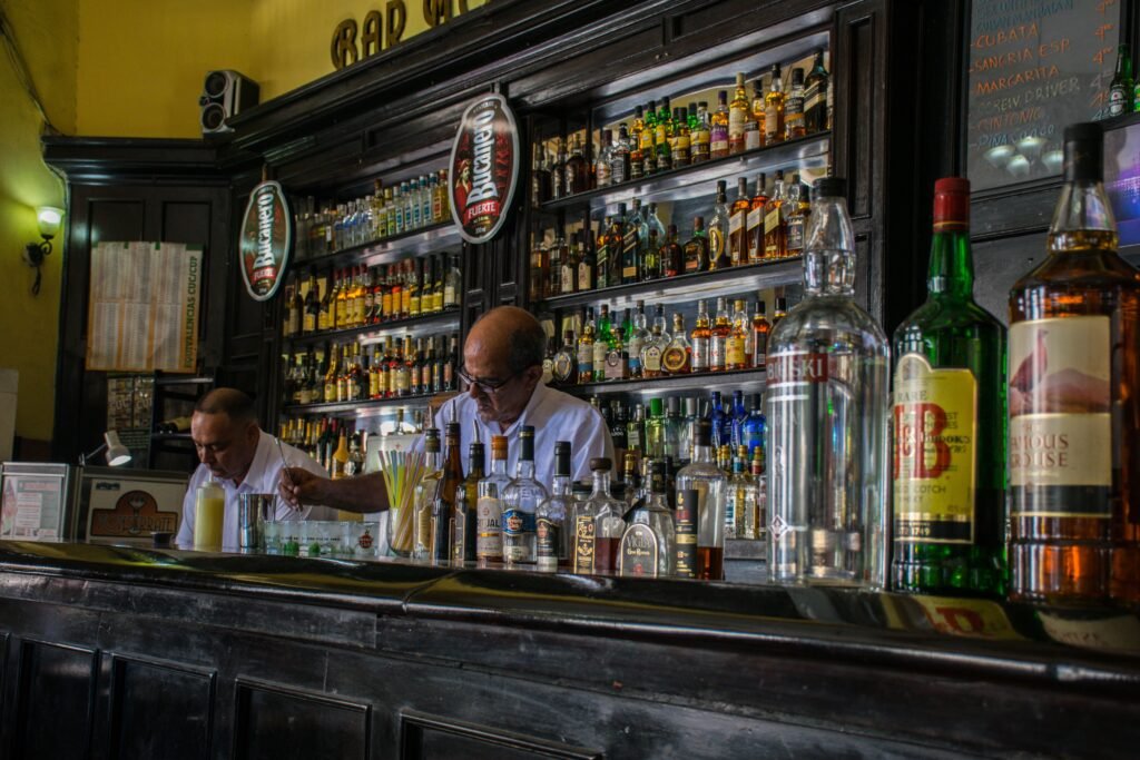 pexels-photo-8804894-8804894 Explore a vibrant Havana bar with bartenders amidst a vast collection of liquors.